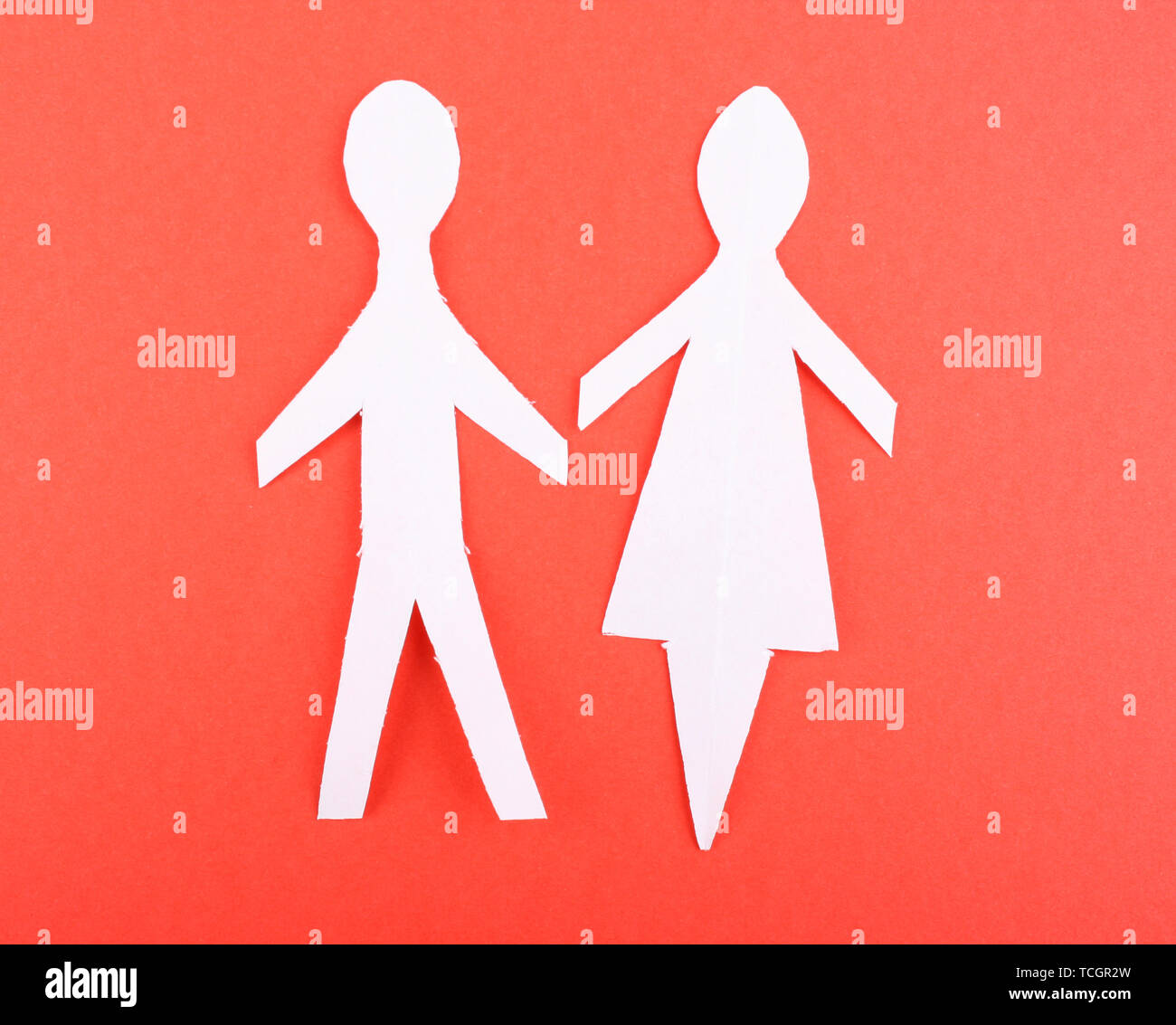 Paper people on red background Stock Photo - Alamy