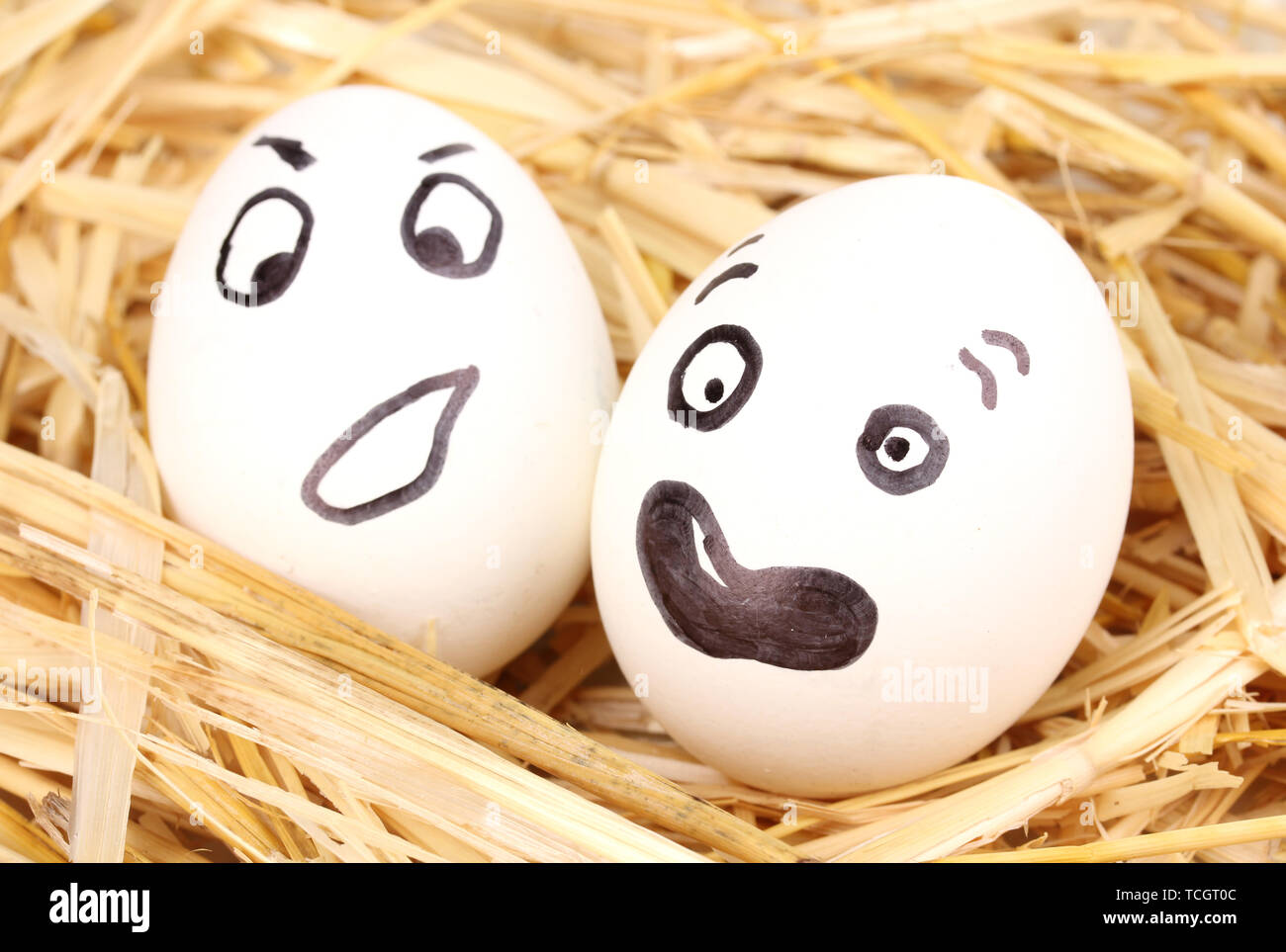White eggs with funny faces in straw Stock Photo - Alamy