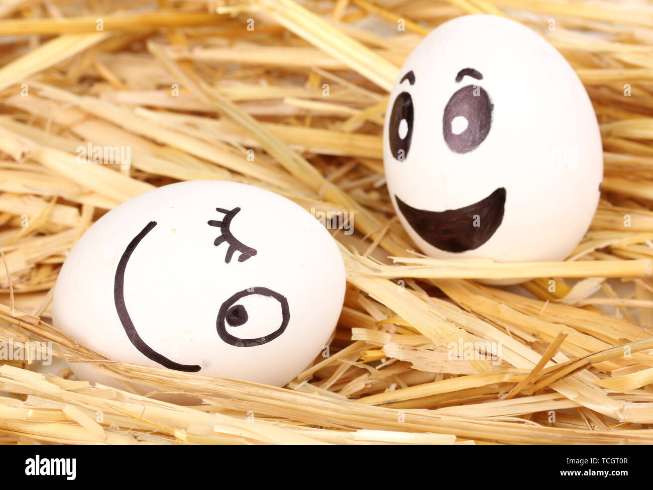 White eggs with funny faces in straw Stock Photo - Alamy