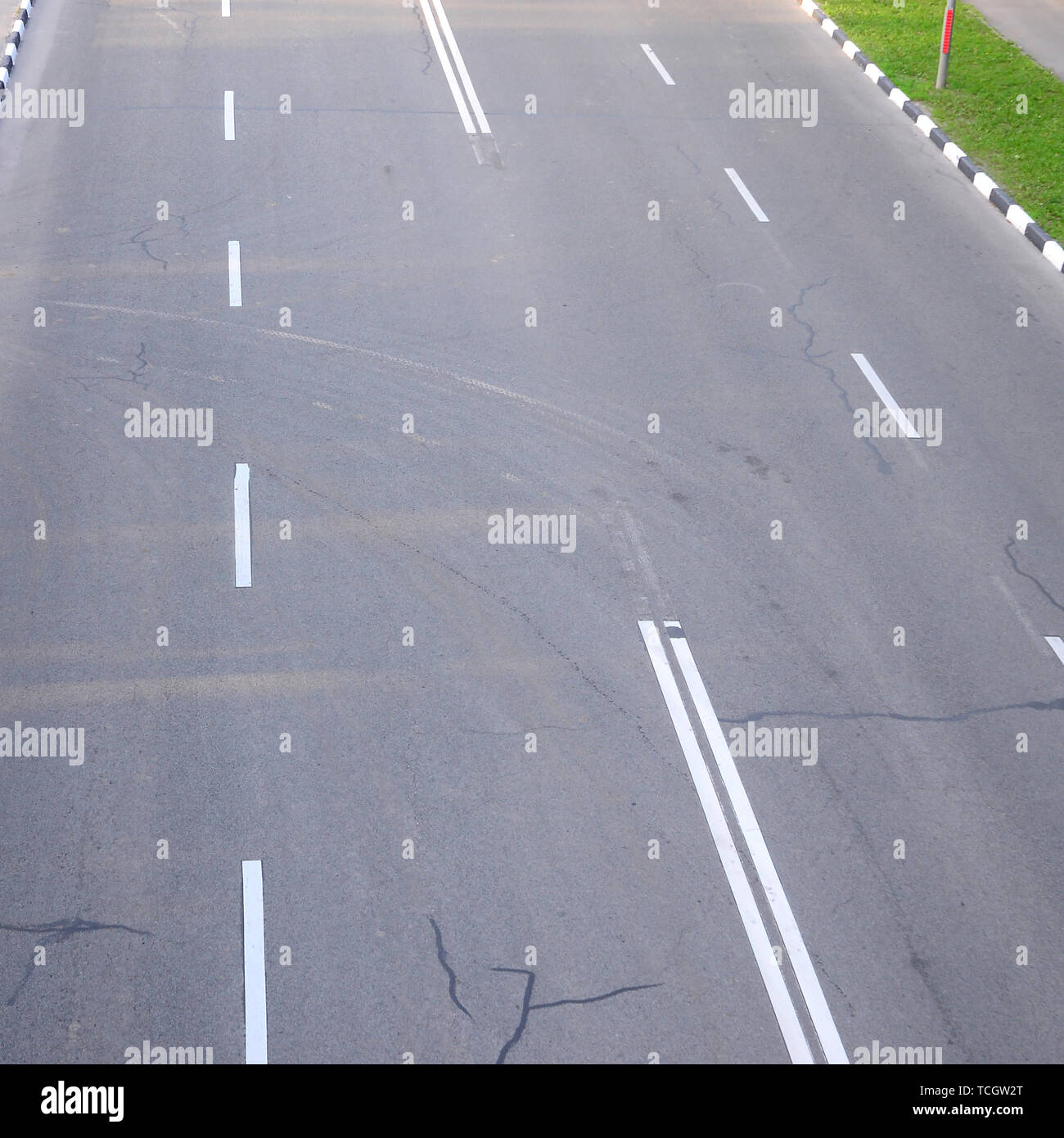 Damaged bad asphalt road with potholes. Patch repair of asphalt. Bad