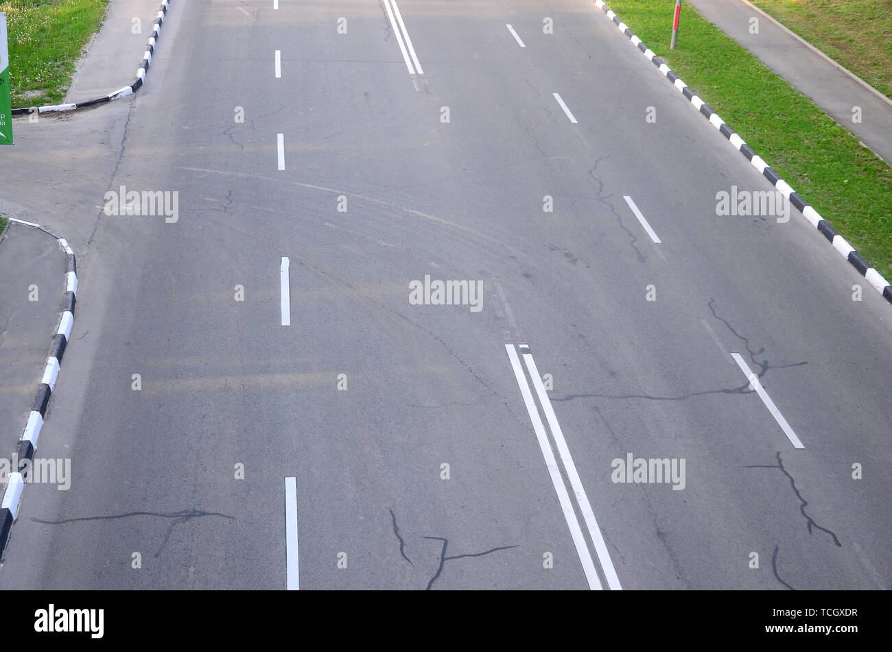 Damaged bad asphalt road with potholes. Patch repair of asphalt. Bad