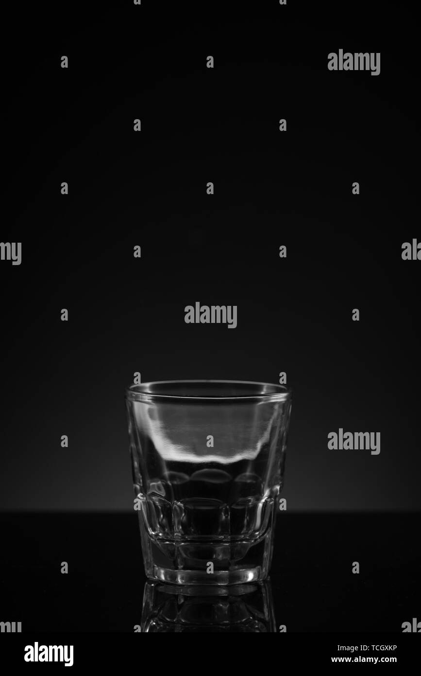 Stacked clear glass shot glasses black background reflective surface Stock Photo Alamy
