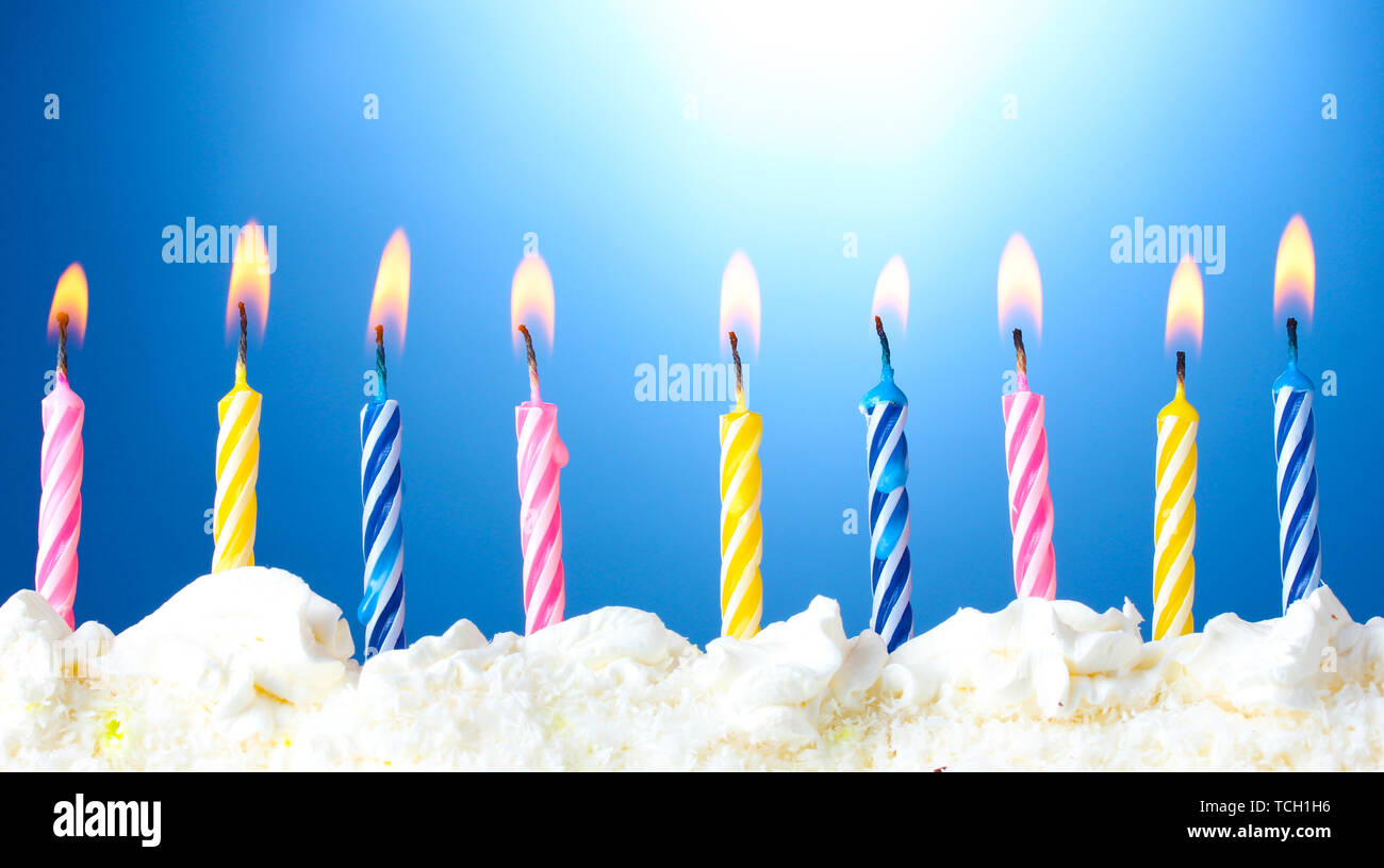 beautiful birthday candles on blue background Stock Photo - Alamy