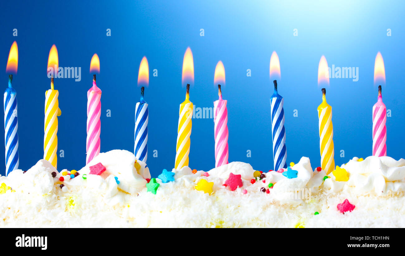 beautiful birthday candles on blue background Stock Photo - Alamy