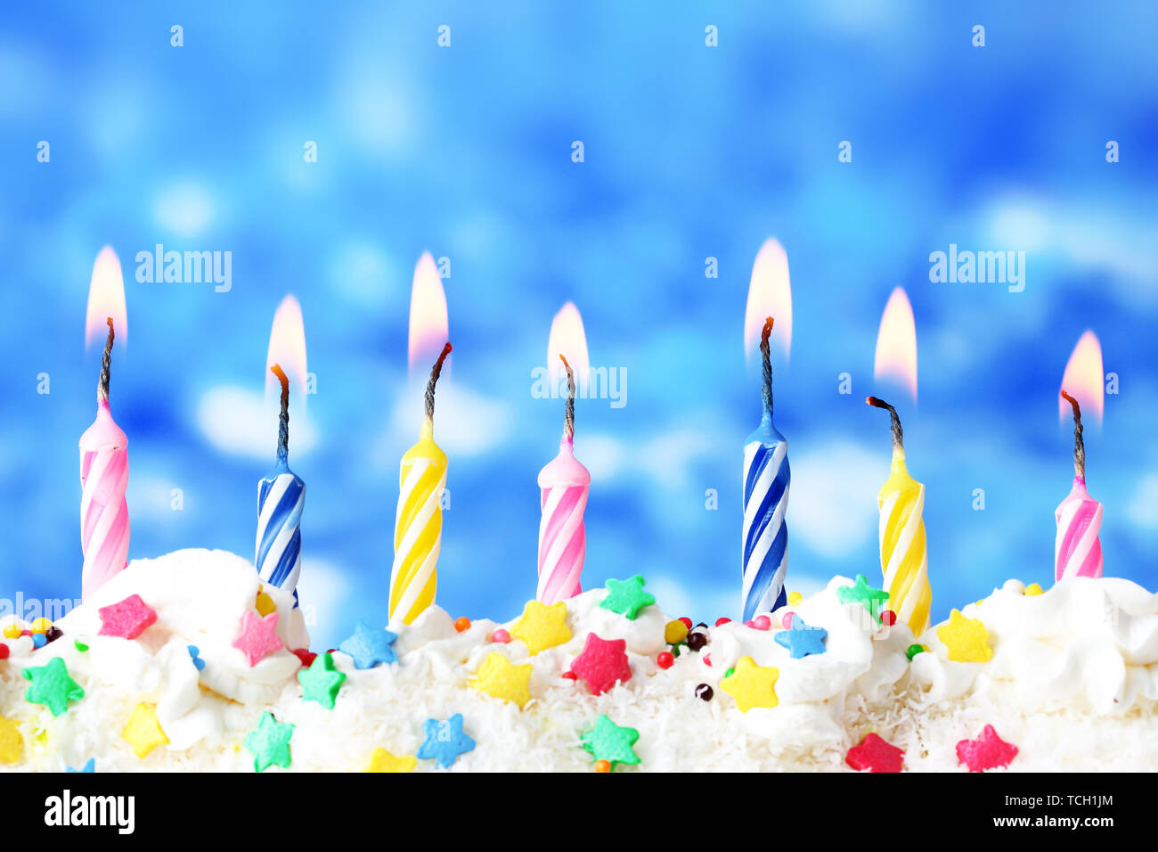 beautiful birthday candles on blue background Stock Photo - Alamy