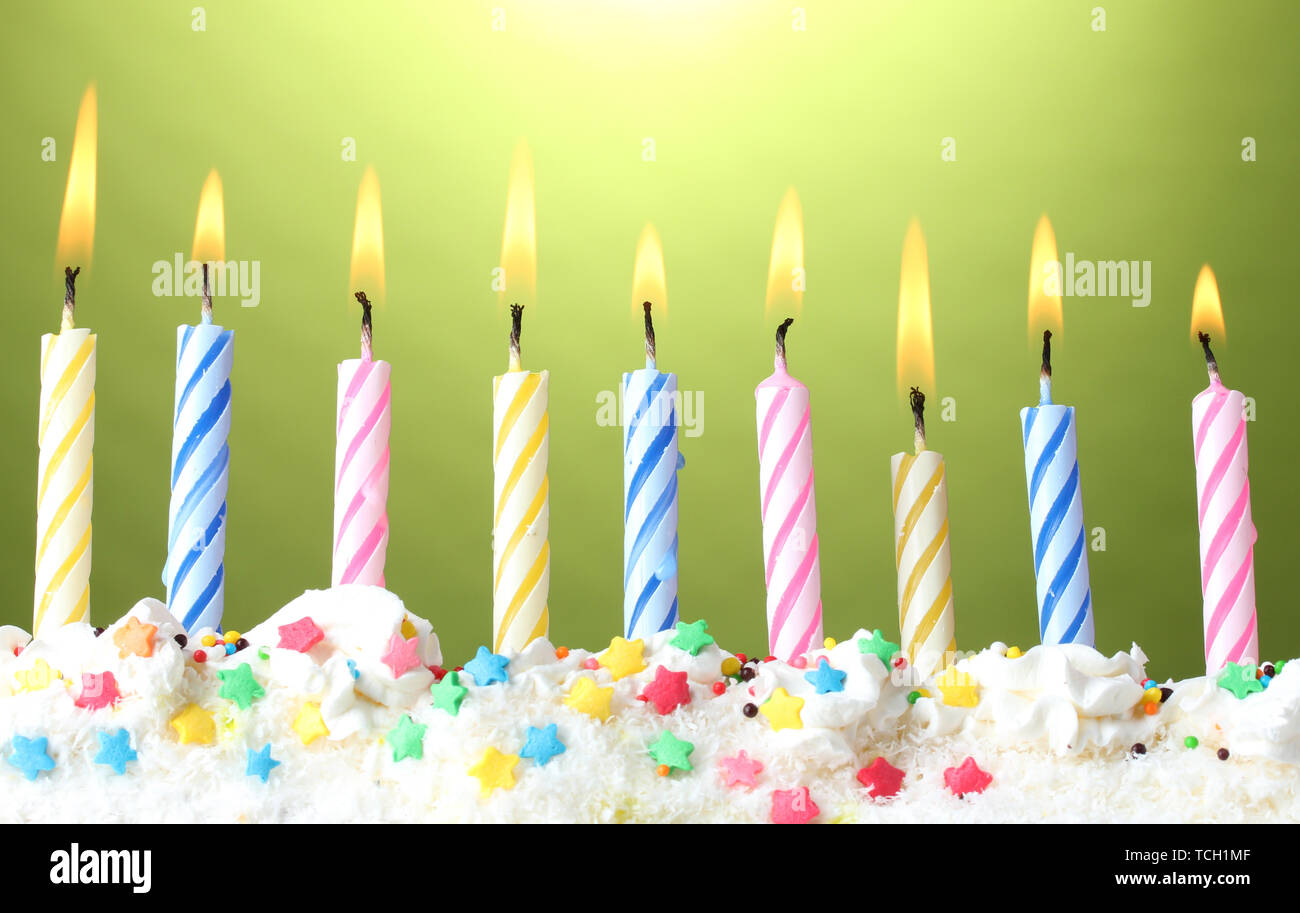 beautiful birthday candles on green background Stock Photo - Alamy