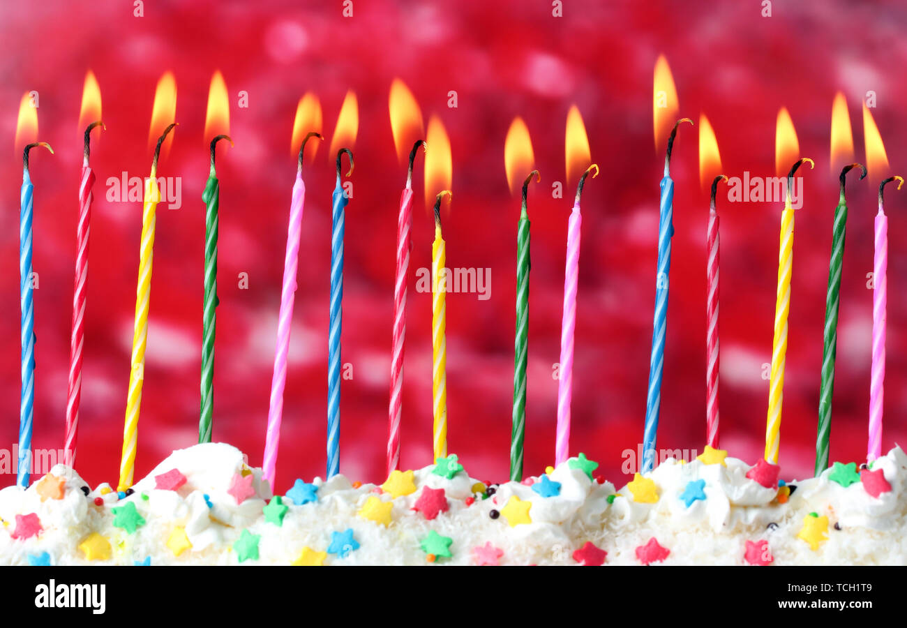 beautiful birthday candles on red background Stock Photo - Alamy