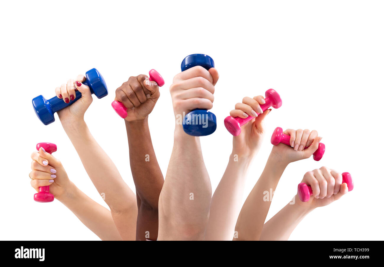 Group Of Man And Woman's Hand Holding Dumbbells In A Row Against White Background Stock Photo