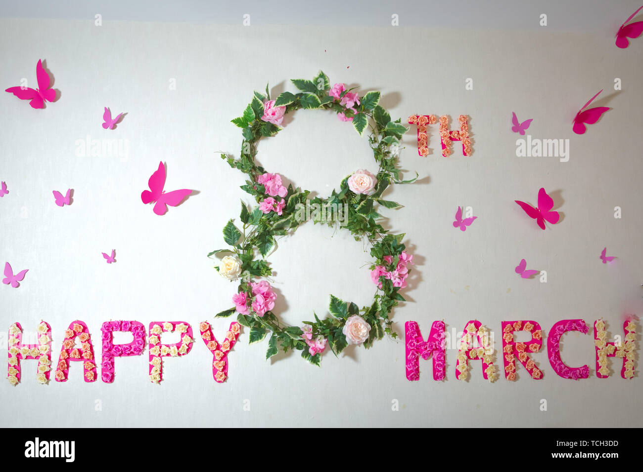 Flower and petals 8 March written on white background . Happy 8 Marhch