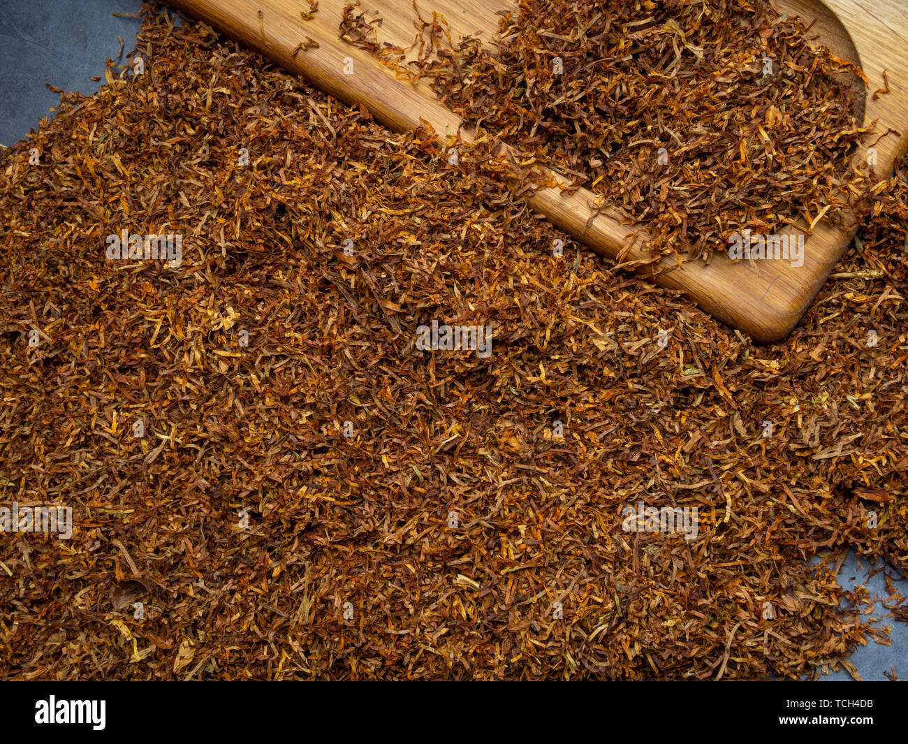 Dry tobacco leaves. High quality tobacco on wooden board close up
