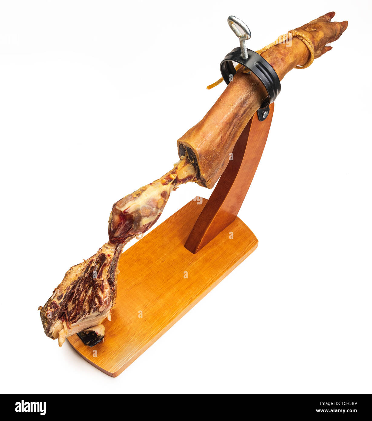 Partial leg of Spanish Iberian ham in wooden support (ham holder). Ham finished and in the bones