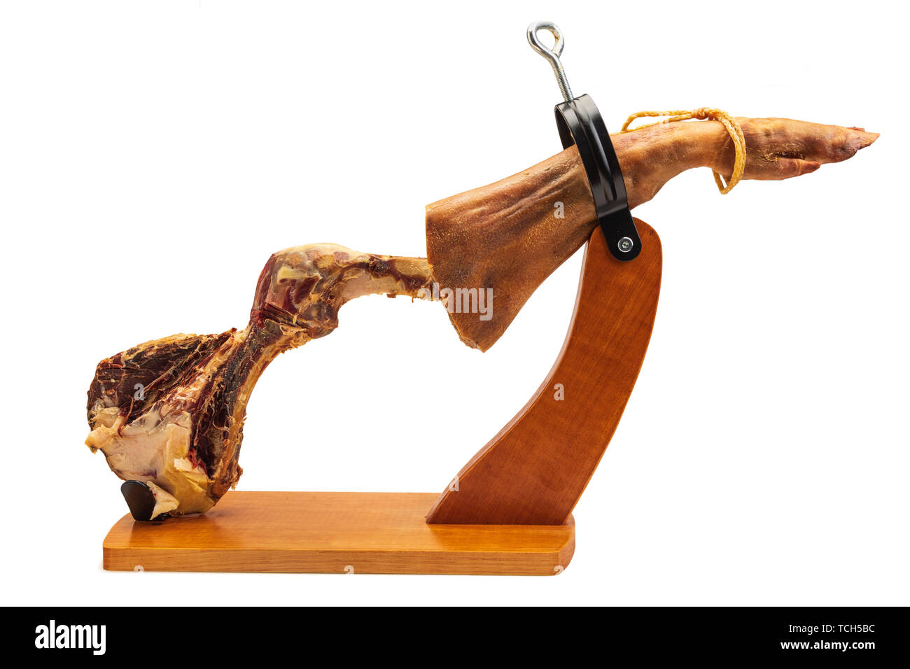 Partial leg of Spanish Iberian ham in wooden support (ham holder). Ham finished and in the bones