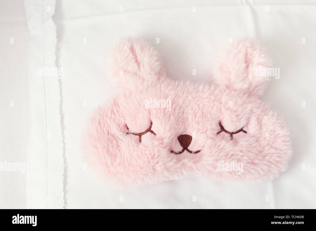 White Bedding Sheet Blanket And Pillows With Cute Pink Sleep Mask