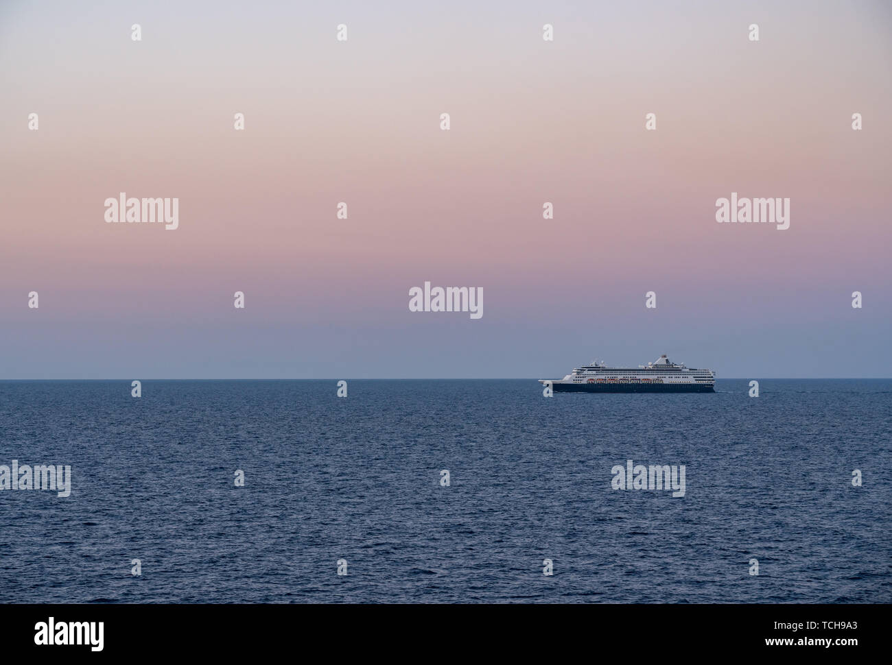 Cruise ship sailing the seas at sunrise or dawn Stock Photo - Alamy
