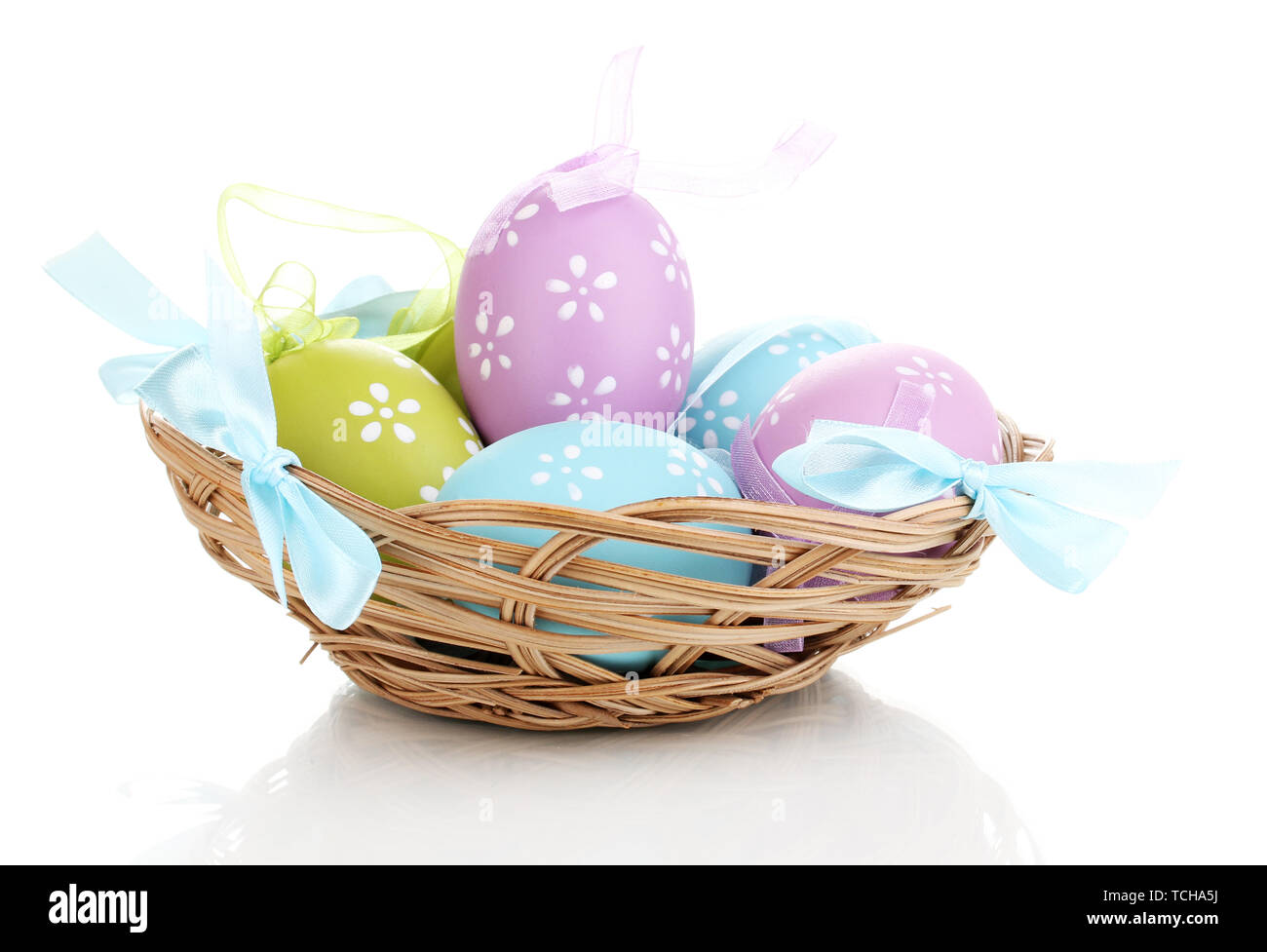 Colorful easter eggs in basket isolated on white Stock Photo - Alamy