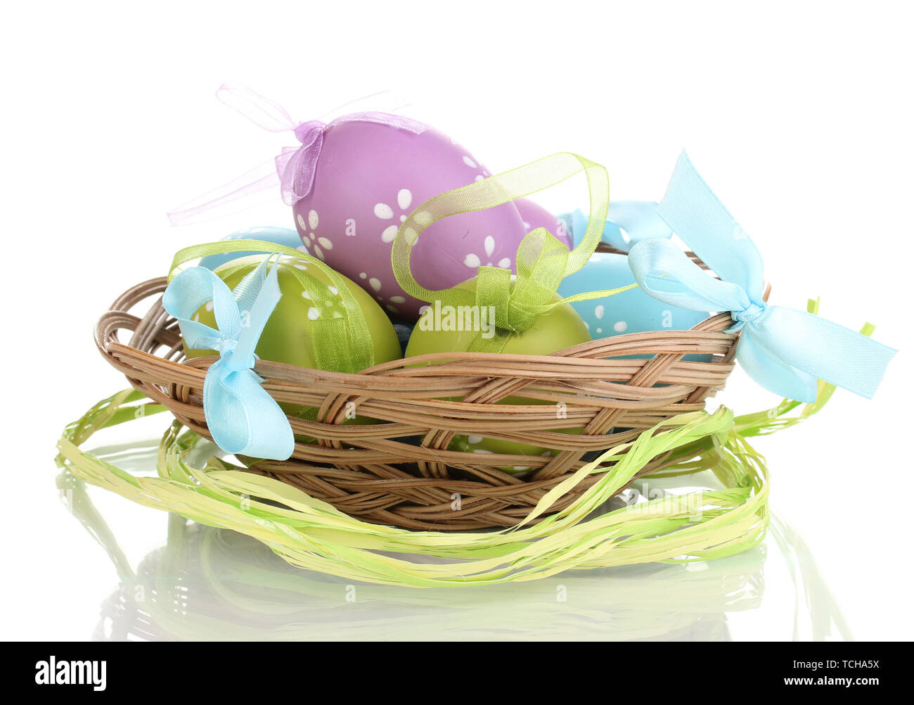 Colorful easter eggs in basket isolated on white Stock Photo - Alamy