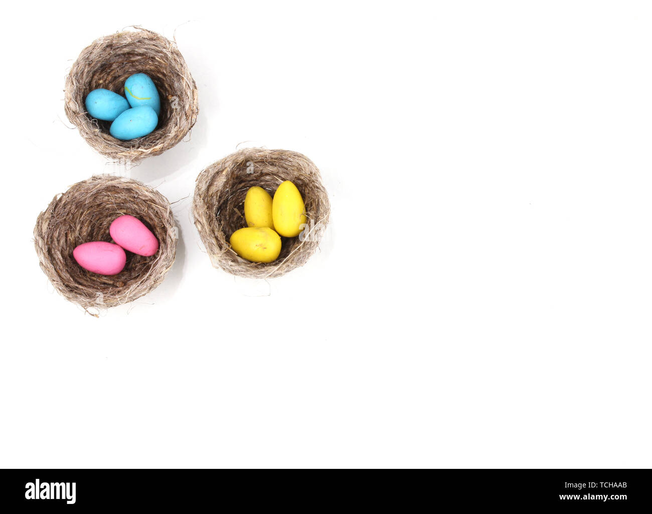 Colorful easter eggs in nests isolated on white Stock Photo