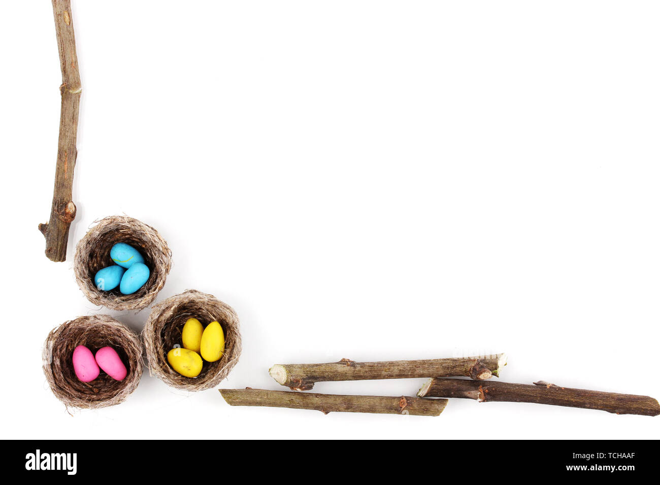 Colorful easter eggs in nests isolated on white Stock Photo