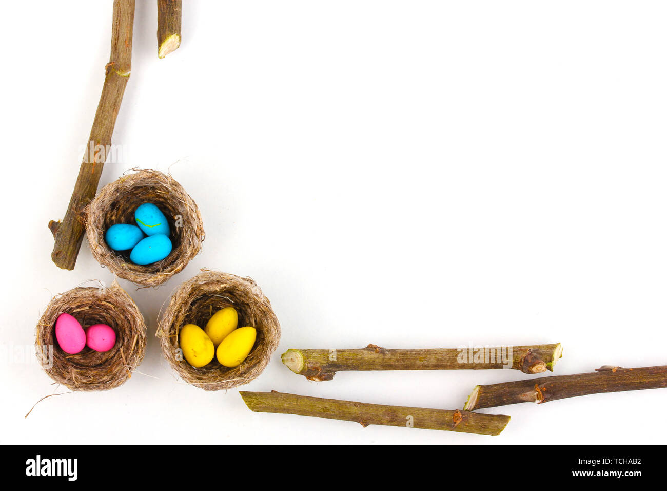 Colorful easter eggs in nests isolated on white Stock Photo
