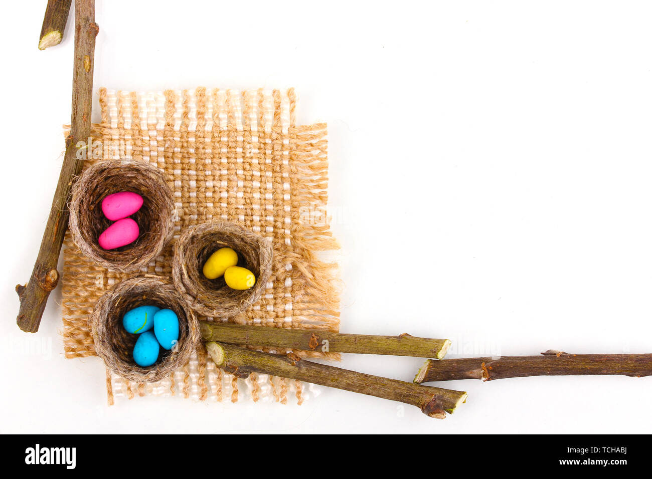 Colorful easter eggs in nests isolated on white Stock Photo