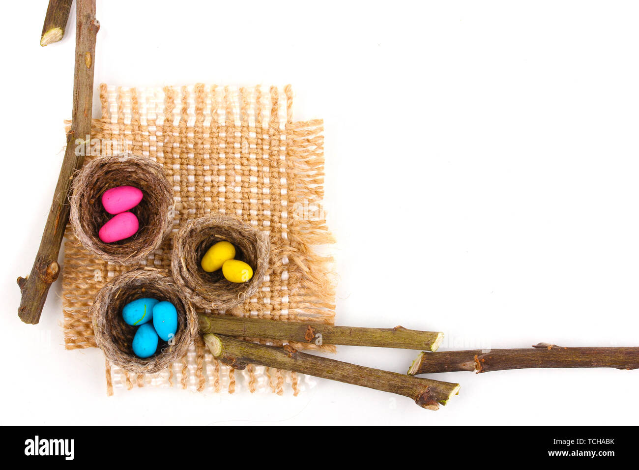 Colorful easter eggs in nests isolated on white Stock Photo