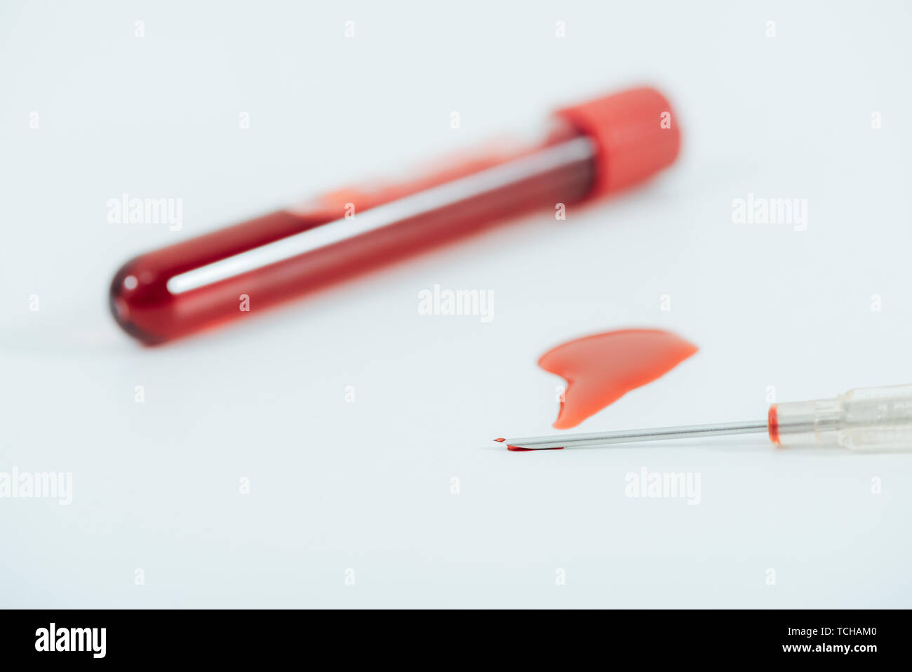 test tube with blood and syringe on white surface Stock Photo - Alamy