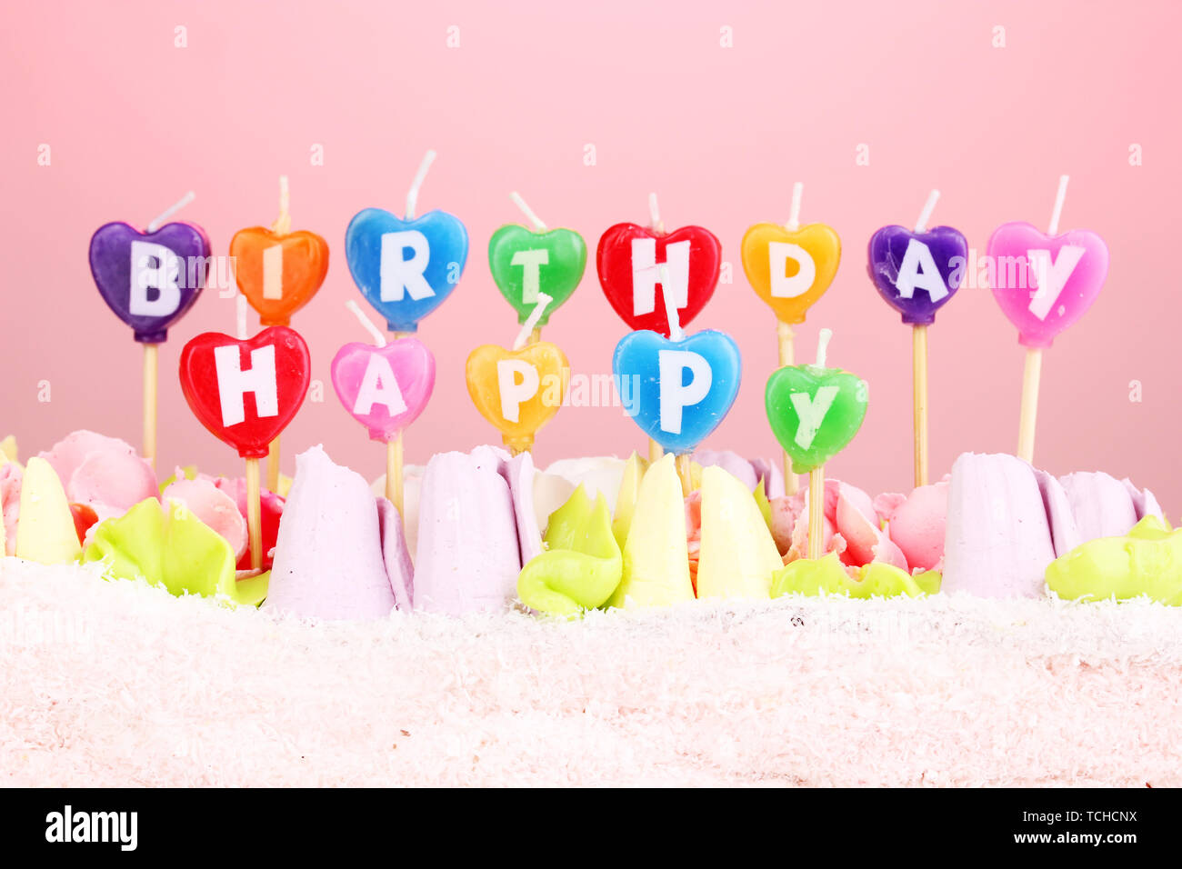 Birthday cake with candles on pink background Stock Photo - Alamy