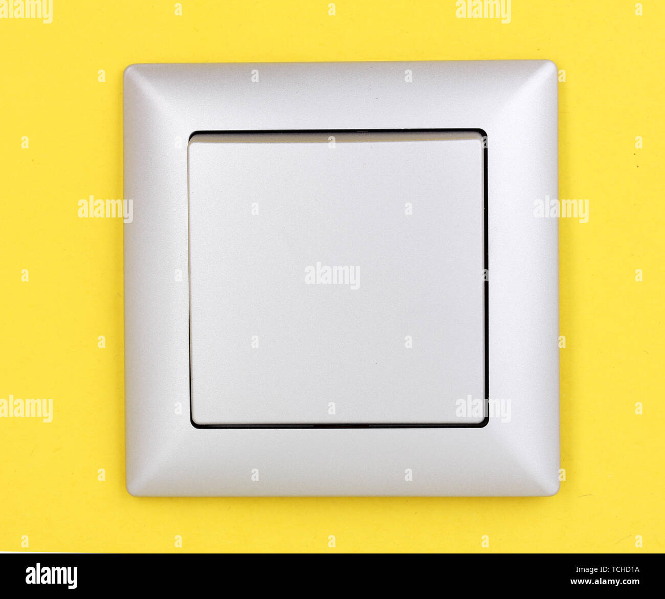 Modern light switch on yellow background Stock Photo