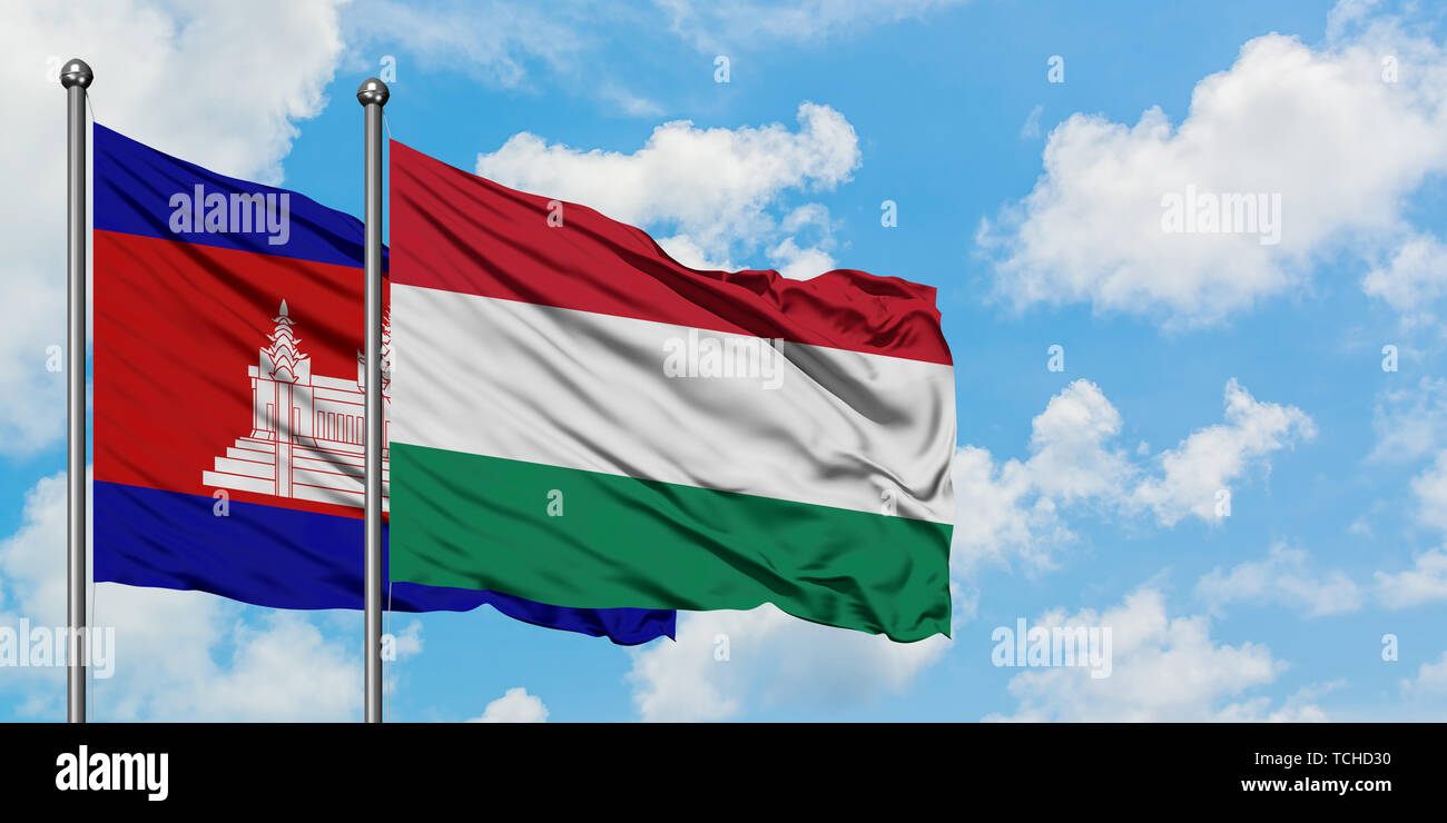 Cambodia and Hungary flag waving in the wind against white cloudy blue sky together. Diplomacy concept, international relations. Stock Photo