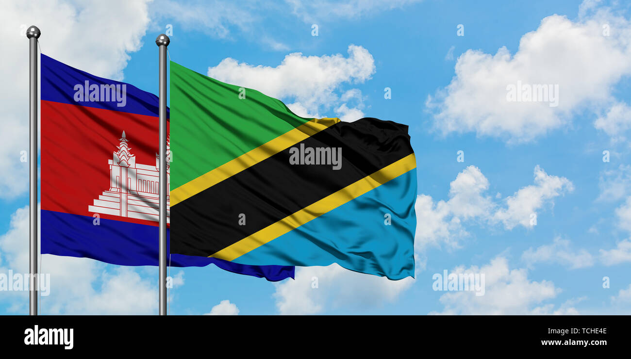 Cambodia and Tanzania flag waving in the wind against white cloudy blue ...