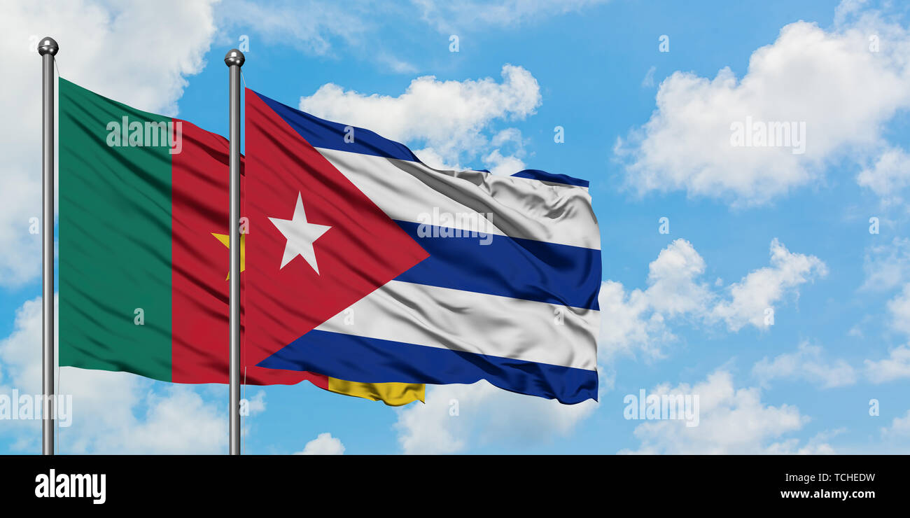 Cameroon and Cuba flag waving in the wind against white cloudy blue sky together. Diplomacy concept, international relations. Stock Photo