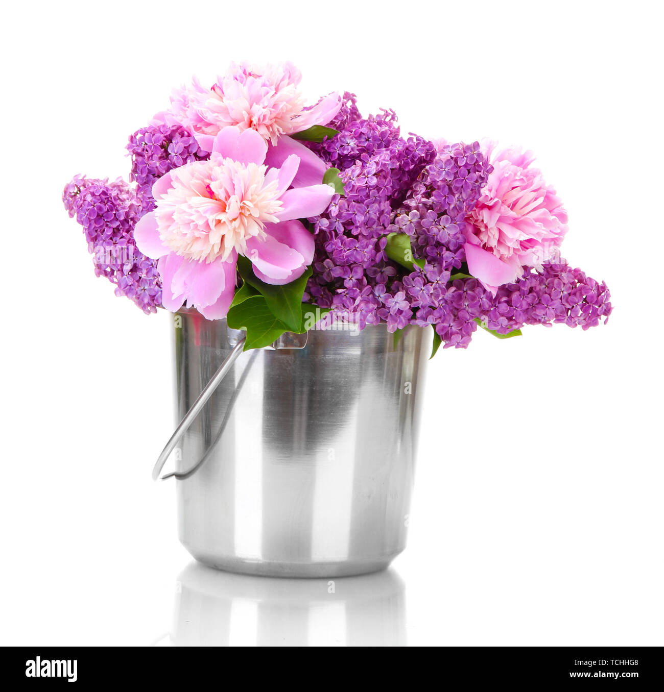 beautiful lilac and peonies flowers in metal bucket isolated on white