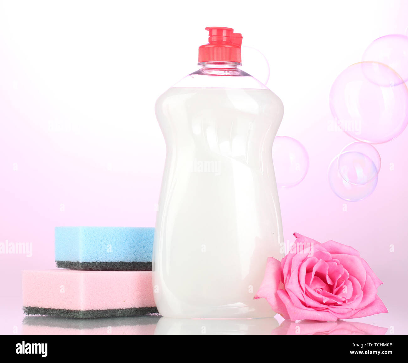 https://c8.alamy.com/comp/TCHM0B/dishwashing-liquid-with-sponges-and-flower-on-pink-background-TCHM0B.jpg