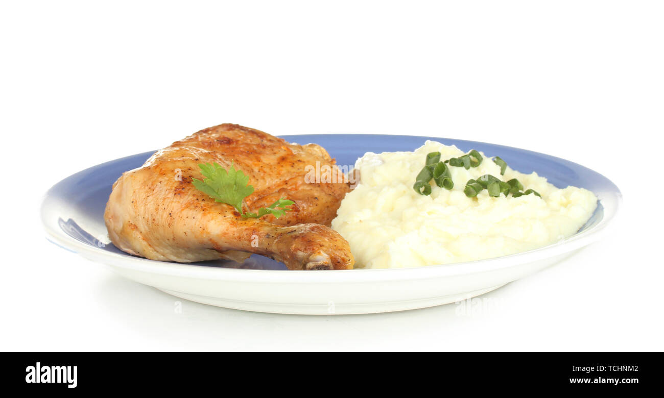 roasted chicken leg with mashed potato in the plate isolated on white