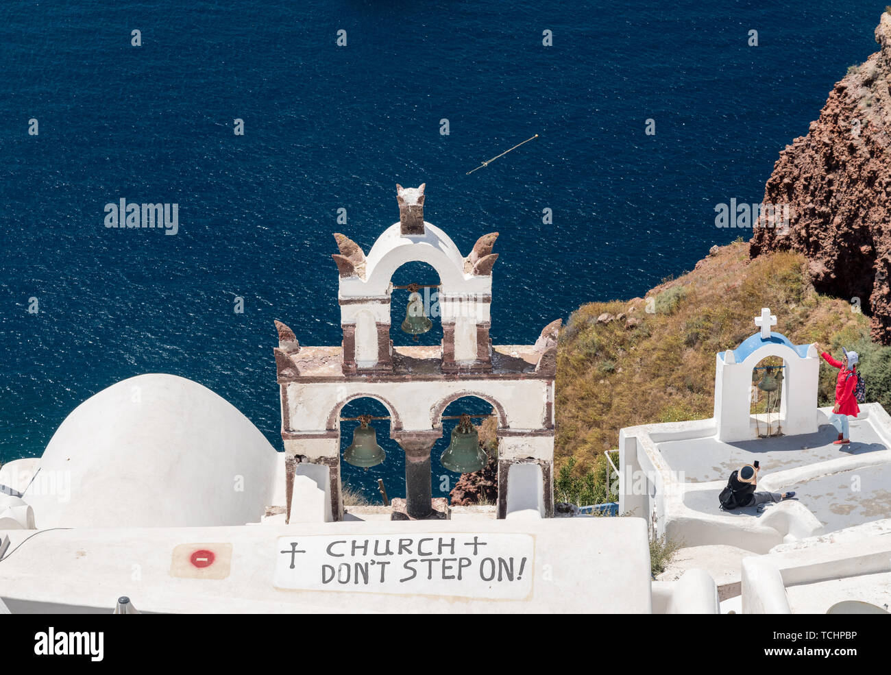 Do not step sign on roof of church in Santorini Stock Photo