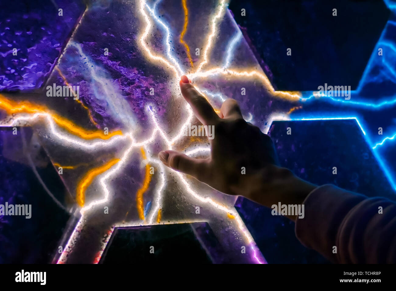 Woman touching plasma panel display Stock Photo
