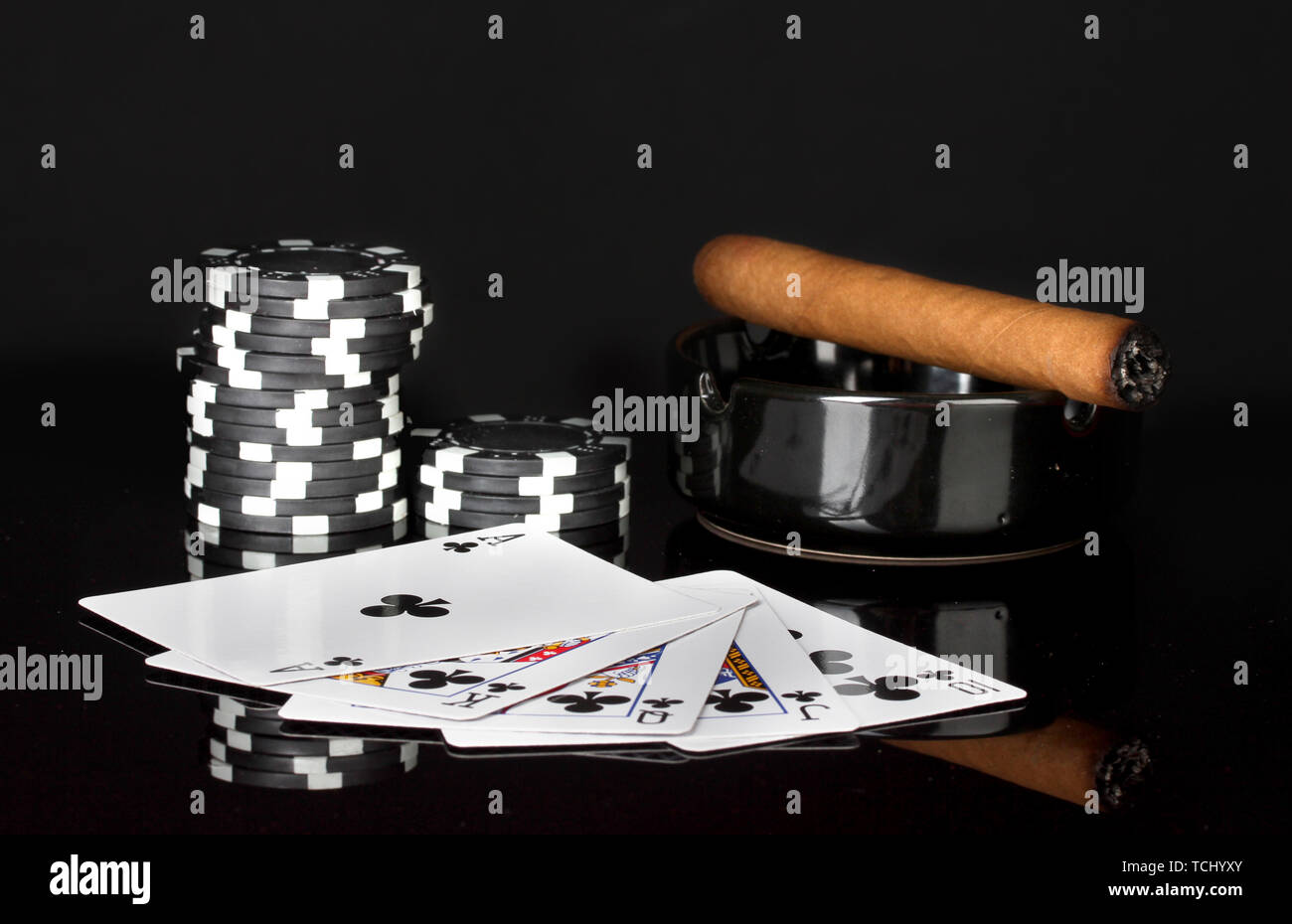 royal flush with poker chips on black background Stock Photo - Alamy