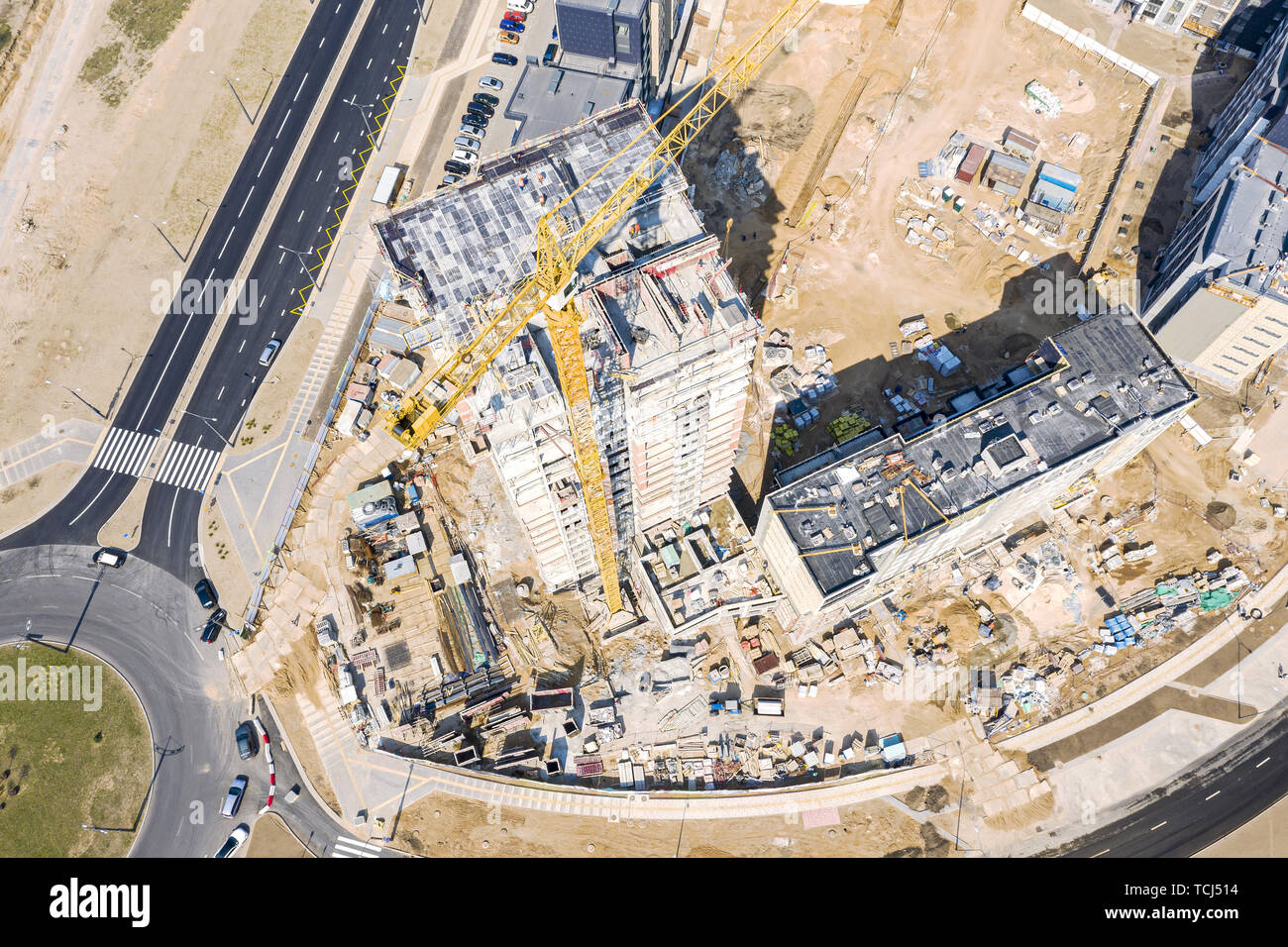 aerial top view of construction site with high yellow tower crane ...