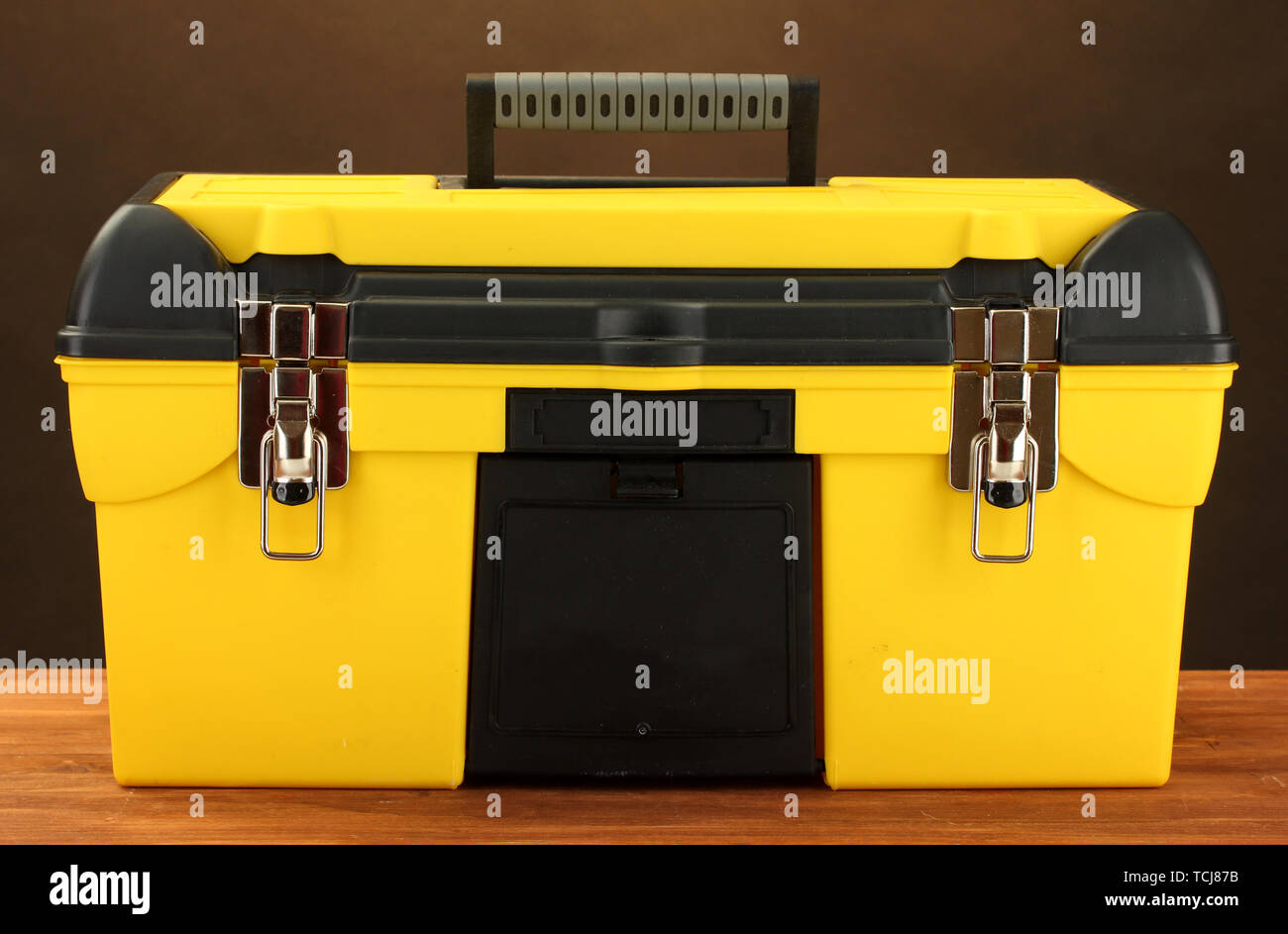 yellow tool box on brown background close-up Stock Photo - Alamy