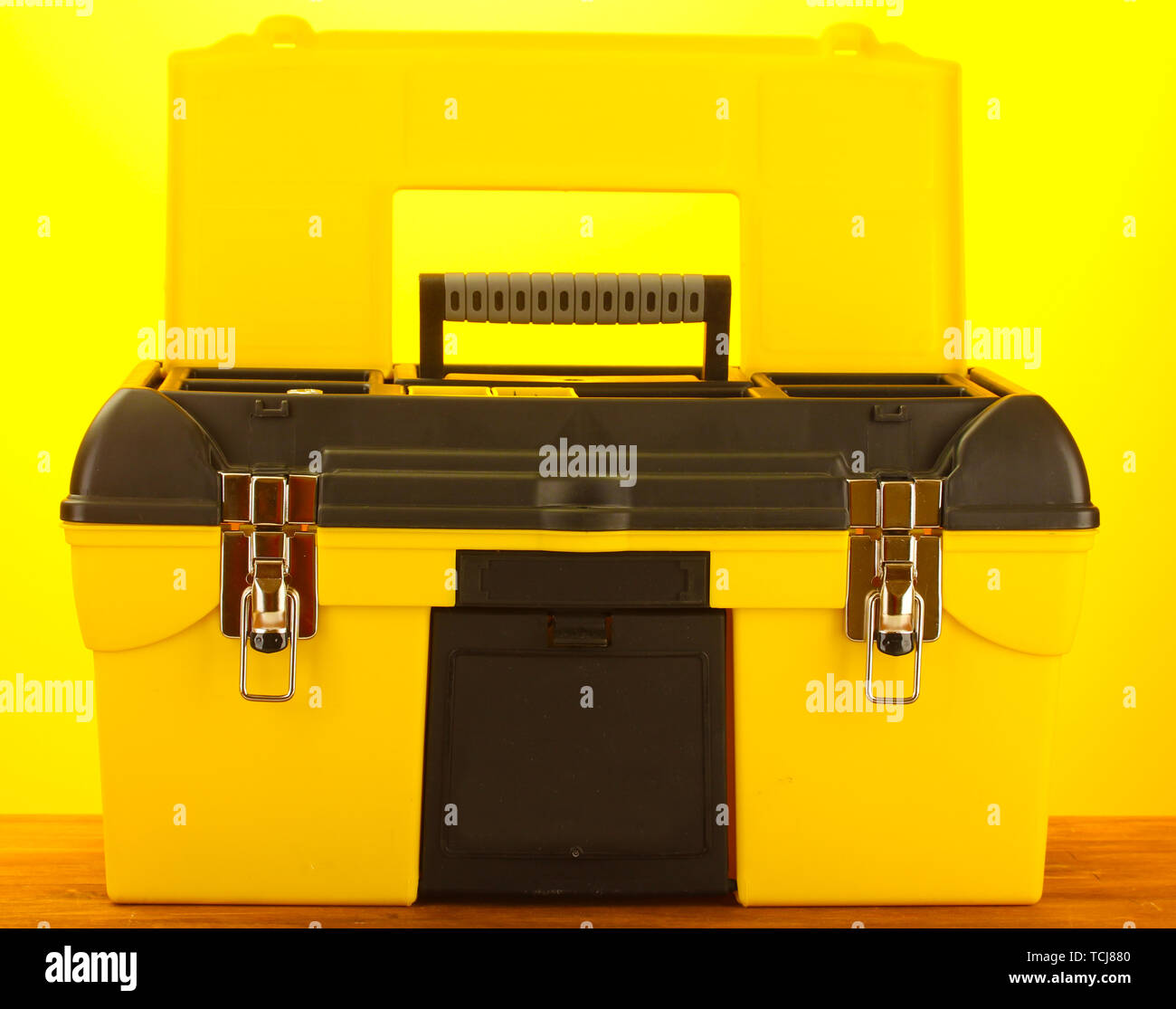 Open yellow tool box on yellow background close-up Stock Photo - Alamy