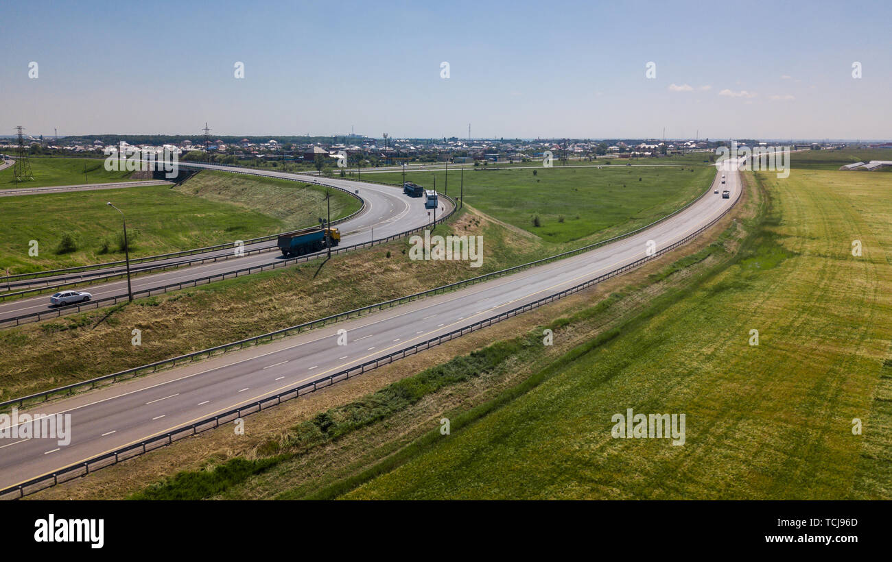 Aerial view of modern highway road intersection on rural landscape ...