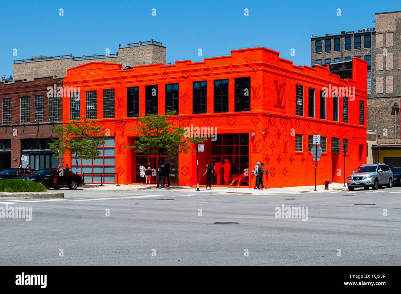 West Loop, Chicago-June 7, 2019: A Louis Vuitton pop-up retail store on the Near West Side of the city is painted neon orange. Stock Photo