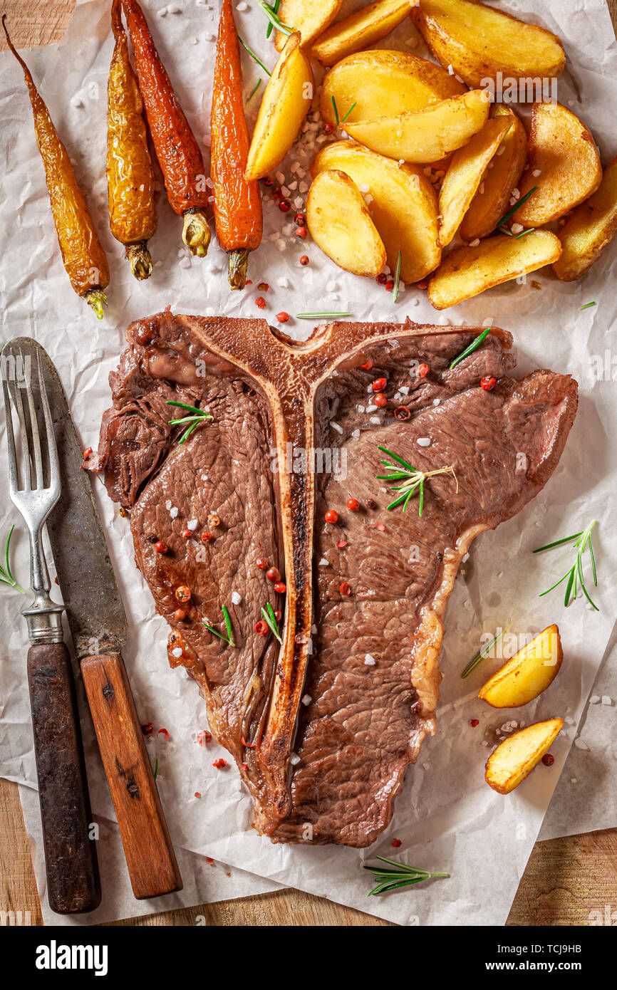 Top view of tbone steak with potatoes and roasted vegetables Stock