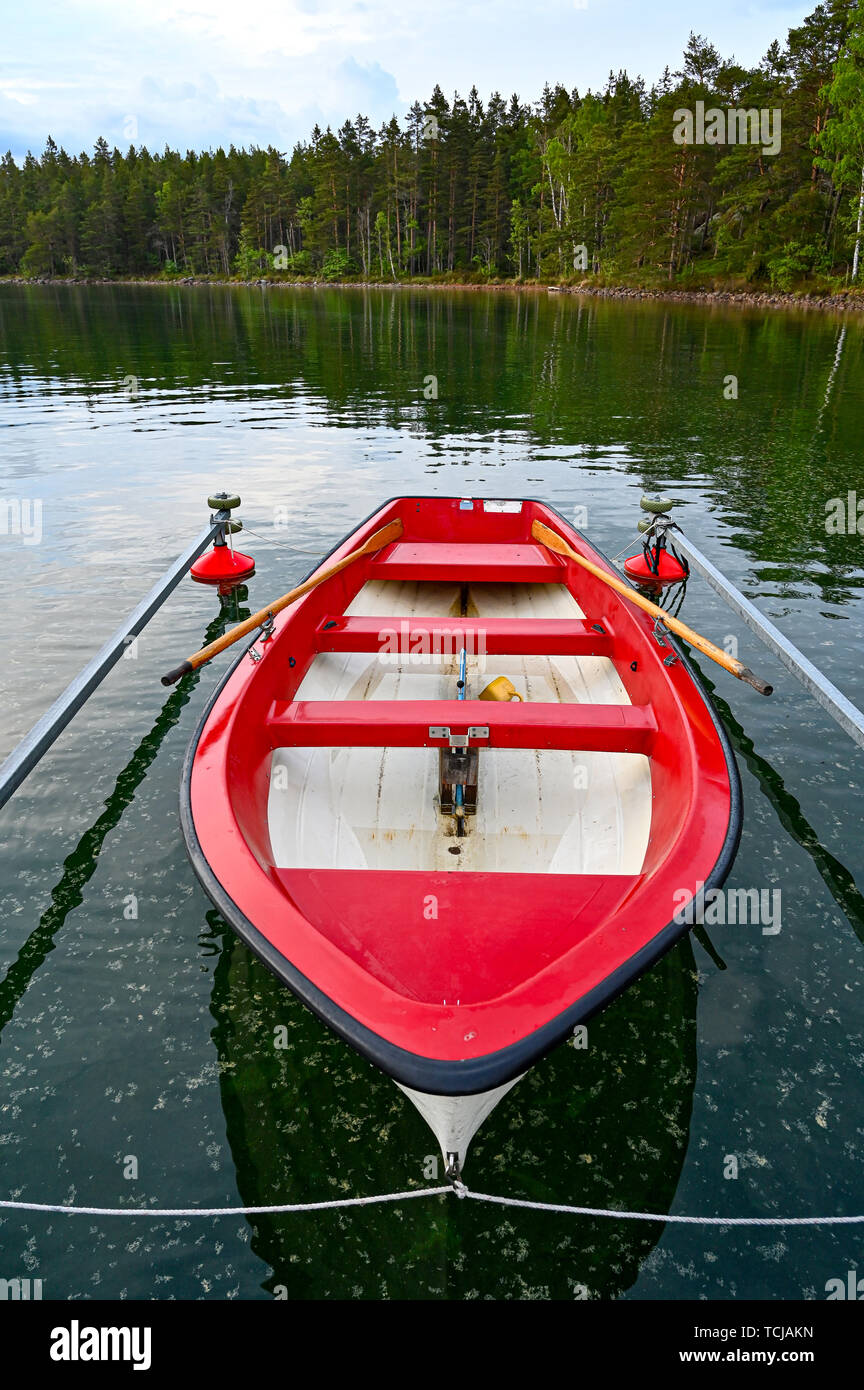 little red and white skiff in Swedish lake Stock Photo Alamy
