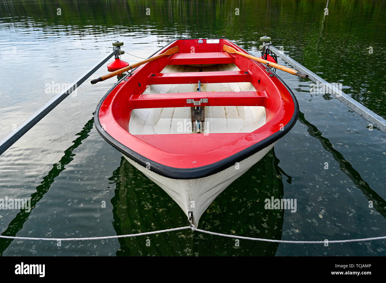 little red and white skiff in Swedish lake Stock Photo Alamy
