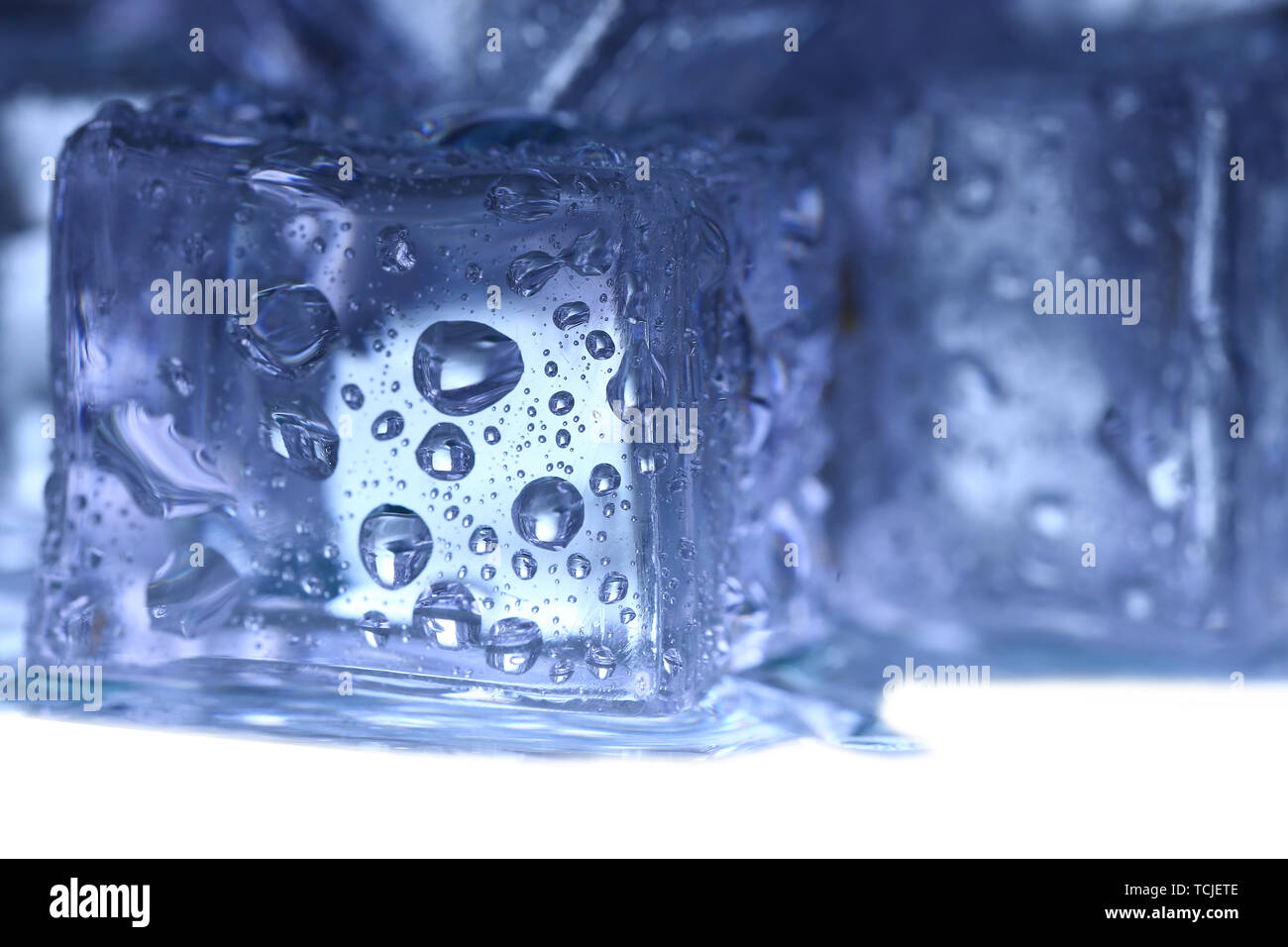 Ice cubes on white background Stock Photo - Alamy