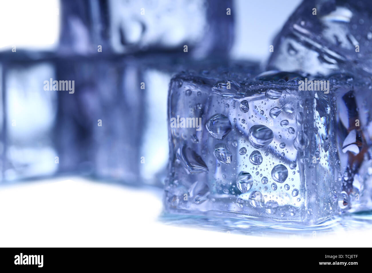 Ice cubes on white background Stock Photo - Alamy