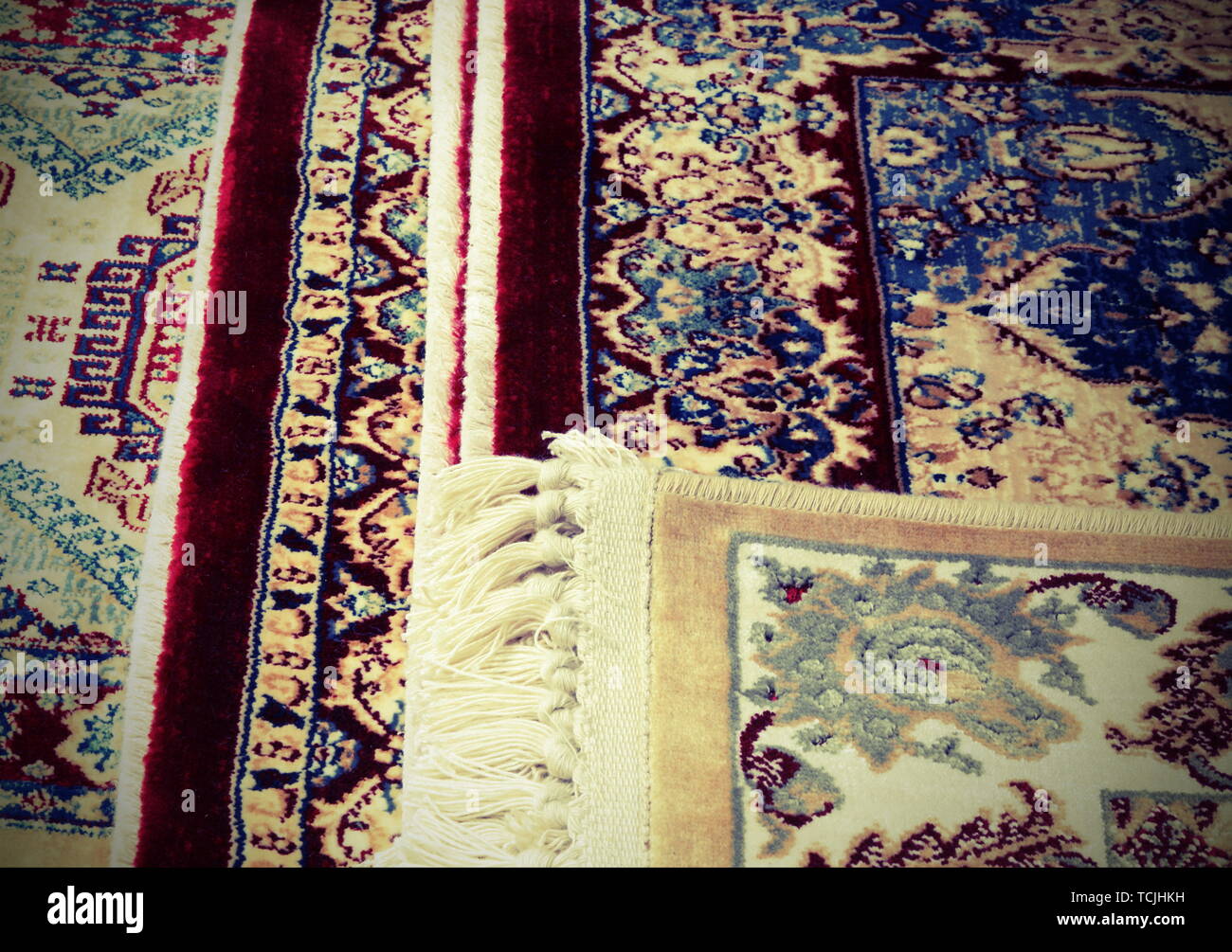 detail of Persian rugs for sale in the ethnic market stall with vintage