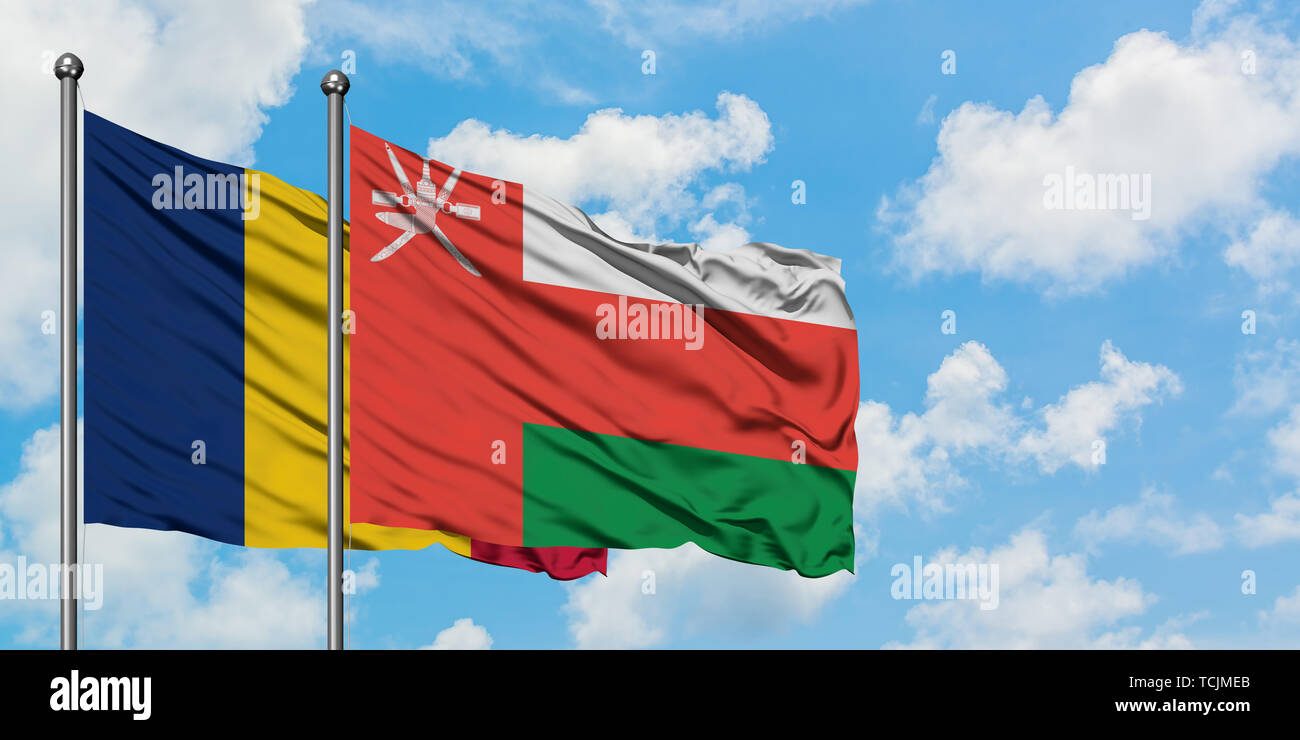 Chad and Oman flag waving in the wind against white cloudy blue sky together. Diplomacy concept, international relations. Stock Photo
