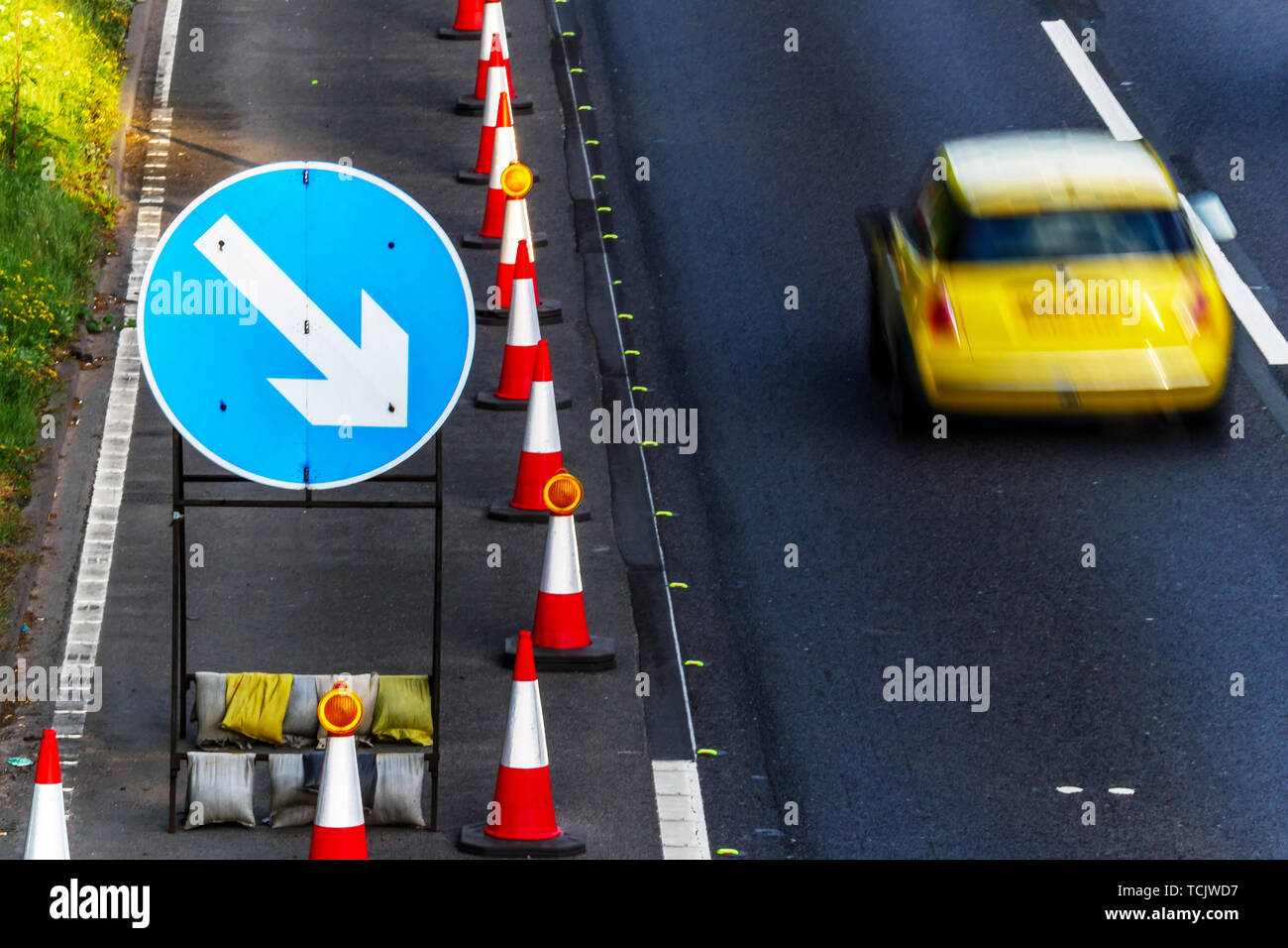 UK Road Services Roadworks Cones and directional Signs on motorway with